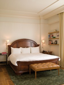 View of bed and bench in the 1 Bedroom Fireplace suite