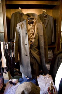 Styled dress form with an overcoat, suit, bowtie and scarf at J. Crew at the Liquor Store