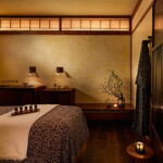 A Shibui Spa treatment room. View of the treatment table/bed, and the earthy decor